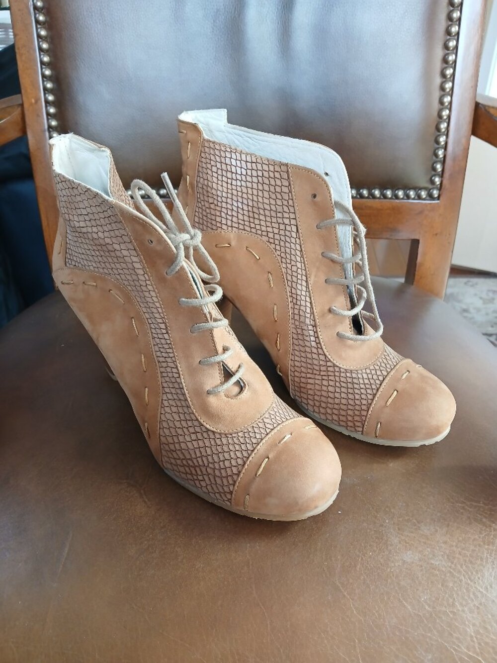 Novel short boot design in contrasting leathers.